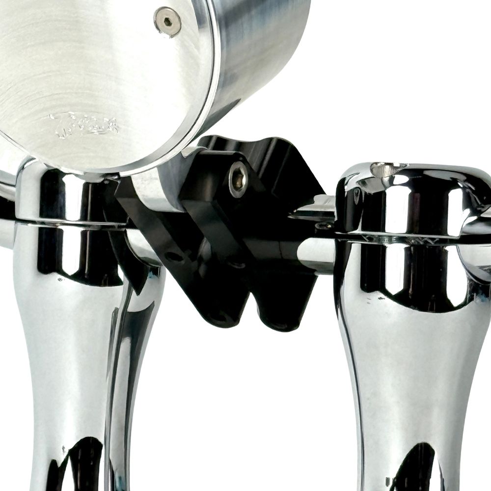 Close-up view of the TC Bros. Pro Series 1" Universal Gauge Mount, a shiny chrome-plated bracket with cylindrical parts by TC Bros., perfect for Harley-Davidson gauge relocation.