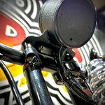 The Guerrilla Cables Speedometer Relocation Harness for 2014-2022 Harley-Davidson Sportster (Single Gauge) is a black electrical cable featuring a rectangular connector on one end and a multi-pin connector on the other, coiled into a loose loop—designed by Guerrilla Cables as a plug-and-play solution for relocating your Sportster’s speedometer.
