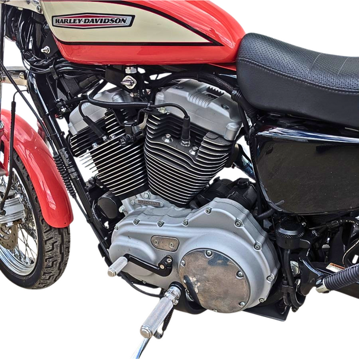 The TC Bros. Nomad Shift/Brake Peg for Harley-Davidson features CNC-machined aluminum pegs in silver, gold, and black with textured grips and threaded bolts. Ideal as a shift or brake peg. "NOMAD SHIFT/TOE PEG" text appears at the top.