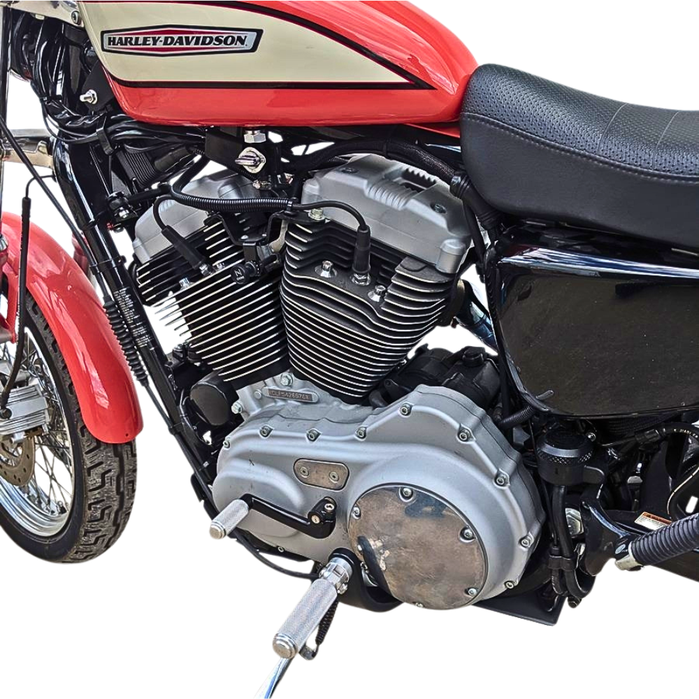 The TC Bros. Nomad Shift/Brake Peg for Harley-Davidson features CNC-machined aluminum pegs in silver, gold, and black with textured grips and threaded bolts. Ideal as a shift or brake peg. "NOMAD SHIFT/TOE PEG" text appears at the top.