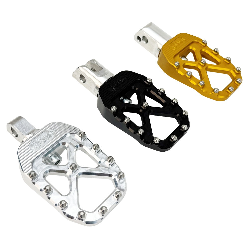 The TC Bros. Pro Series MX Foot Pegs for Harley Davidson come in silver, black, and gold with a rugged, spiked design and diagonal layout for superior grip.