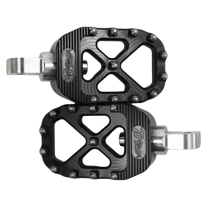 The TC Bros. Pro Series MX Foot Pegs for Harley Davidson come in silver, black, and gold with a rugged, spiked design and diagonal layout for superior grip.