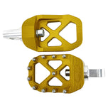 The TC Bros. Pro Series MX Foot Pegs for Harley Davidson come in silver, black, and gold with a rugged, spiked design and diagonal layout for superior grip.