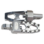 Three TC Bros. Pro Series MX Lite Foot Pegs for Harley Davidson models, featuring metallic spiked surfaces, are arranged side by side in silver, black, and gold.