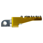 Three TC Bros. Pro Series MX Lite Foot Pegs for Harley Davidson models, featuring metallic spiked surfaces, are arranged side by side in silver, black, and gold.