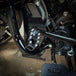 Three TC Bros. Pro Series MX Shifter/Brake Pegs for Harley Davidson, available in silver, black, and gold with multiple spikes, are shown with a metal bolt.