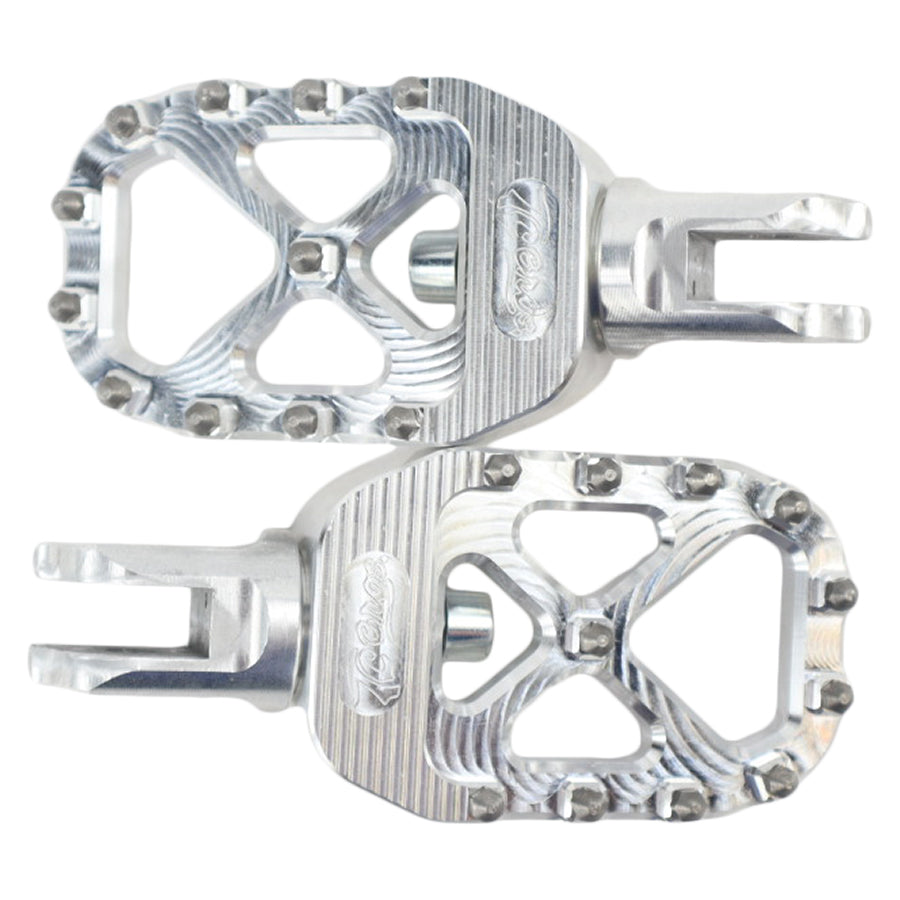 The TC Bros. Pro Series MX Foot Pegs for Harley Davidson come in silver, black, and gold with a rugged, spiked design and diagonal layout for superior grip.