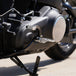 Three TC Bros. Pro Series MX Lite Foot Pegs for Harley Davidson models, featuring metallic spiked surfaces, are arranged side by side in silver, black, and gold.