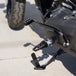 Three TC Bros. Pro Series MX Lite Foot Pegs for Harley Davidson models, featuring metallic spiked surfaces, are arranged side by side in silver, black, and gold.