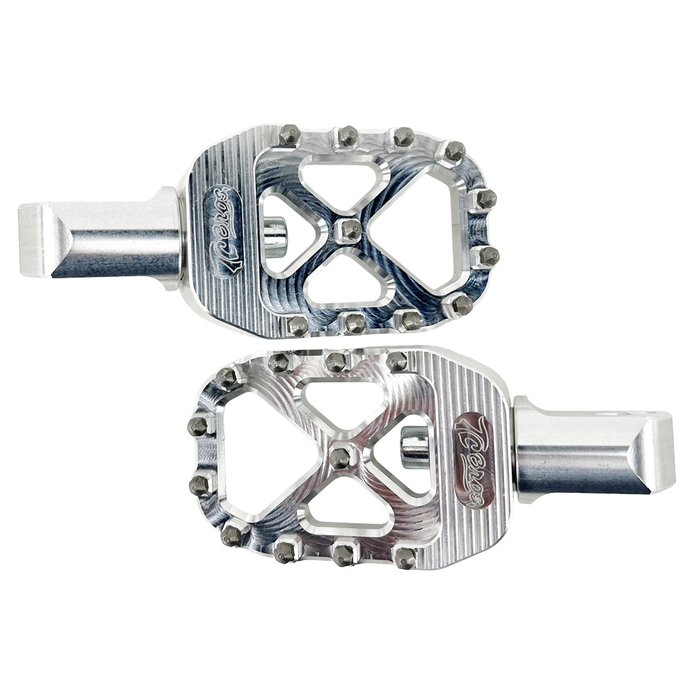 Two silver aluminum bicycle pedals with multiple grip studs, designed for increased traction and control—perfectly inspired by the rugged durability of TC Bros. Pro Series MX Passenger Foot Pegs for 2018-newer Harley Softail & Pan America from TC Bros.