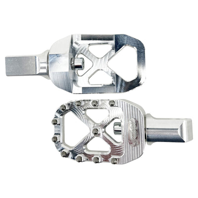 The TC Bros. Pro Series MX Foot Pegs for Harley Davidson come in silver, black, and gold with a rugged, spiked design and diagonal layout for superior grip.