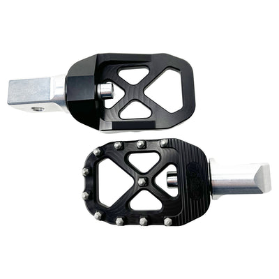 The TC Bros. Pro Series MX Foot Pegs for Harley Davidson come in silver, black, and gold with a rugged, spiked design and diagonal layout for superior grip.