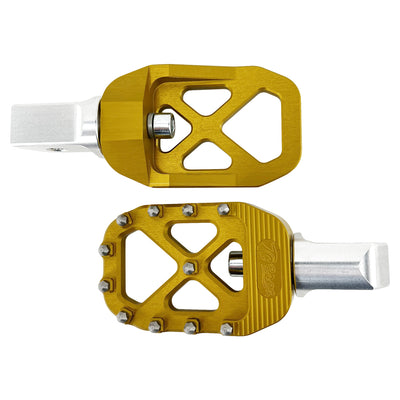 A pair of golden bicycle pedals with a metallic silver base, featuring spiked edges for grip, reminiscent of the rugged design found in TC Bros. Pro Series Gold MX Passenger Foot Pegs for 2018-newer Harley Softail & Pan America by TC Bros.