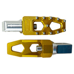Three TC Bros. Pro Series MX Lite Foot Pegs for Harley Davidson models, featuring metallic spiked surfaces, are arranged side by side in silver, black, and gold.