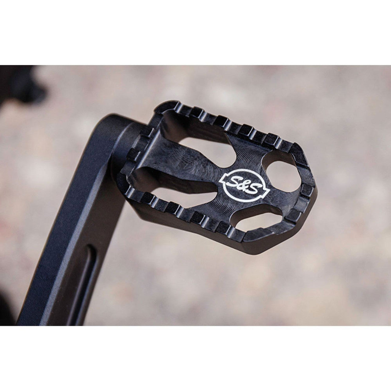 A black Mid Mount Brake Pedal for M8 Softail® Models, including bolts, washers, and additional components laid out separately, reminiscent of the precise craftsmanship seen in S&S Cycle products.