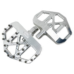 Three TC Bros. Pro Series MX Mini Floorboards for Harley-Davidson, in silver, black, and gold, are diagonally arranged on a white background.