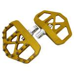Three TC Bros. Pro Series MX Mini Floorboards for Harley-Davidson, in silver, black, and gold, are diagonally arranged on a white background.