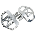 Three TC Bros. Pro Series MX Mini Floorboards for Harley-Davidson, in silver, black, and gold, are diagonally arranged on a white background.