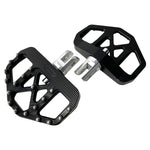 Three TC Bros. Pro Series MX Mini Floorboards for Harley-Davidson, in silver, black, and gold, are diagonally arranged on a white background.