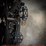 Three TC Bros. Pro Series MX Mini Floorboards for 1977-2022 Harley-Davidson in silver, black, and gold are shown on a white background, each featuring flat metal platforms with grip pins for adjustable foot peg mounting.