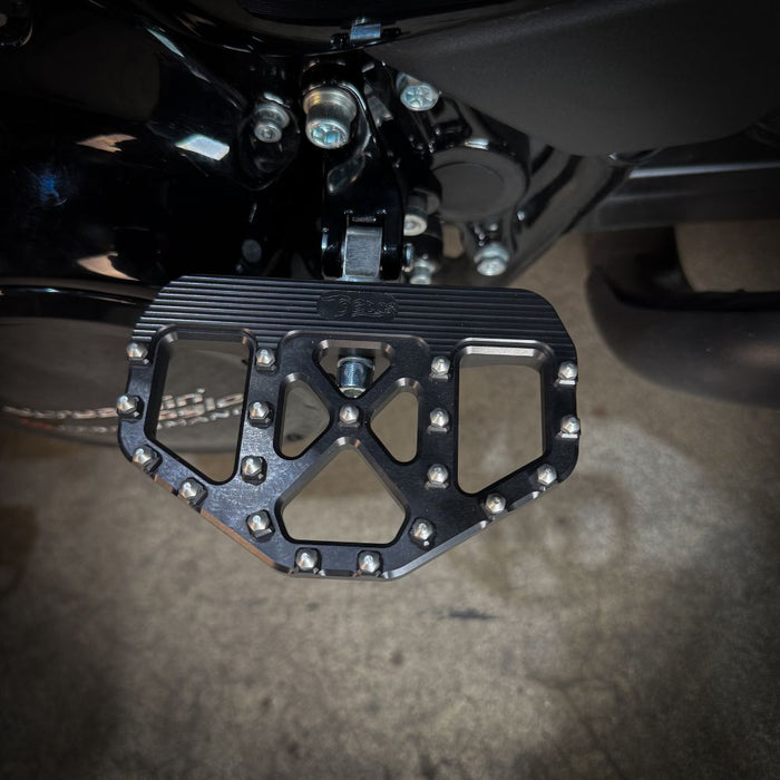 A pair of TC Bros. Pro Series Black MX Passenger Mini Floorboards for 2018-newer Harley Softail & Pan America, isolated on a white background.