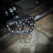 A pair of TC Bros. Pro Series Black MX Passenger Mini Floorboards for 2018-newer Harley Softail & Pan America, isolated on a white background.