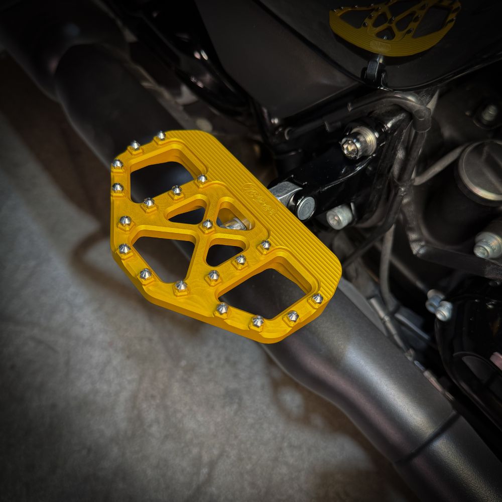 A pair of TC Bros. Pro Series Gold MX Passenger Mini Floorboards for 2018-newer Harley Softail & Pan America, with grip studs, isolated on a white background.