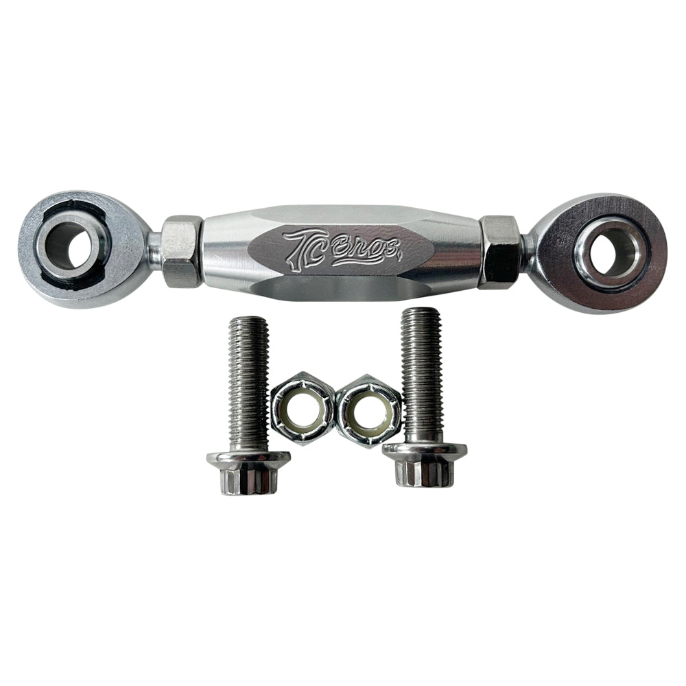 The TC Bros. FXR & M8 Softail Adjustable Shifter Linkage for Mid Controls showcases three adjustable turnbuckle rod ends in black, gold, and silver, arranged vertically. Crafted from CNC machined aluminum, these precision parts are ideal for Harley Davidson shifter linkage applications. Two bolts and two nuts are neatly placed below the rod ends, completing the arrangement.