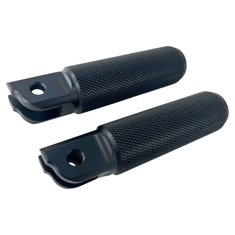Two black, textured, cylindrical metal objects with mounting brackets on one end, possibly TC Bros. Nomad Rider Foot Pegs fits 2018-up Harley Softail M8 & Pan America - Black for a Harley motorcycle, are positioned on a white background.