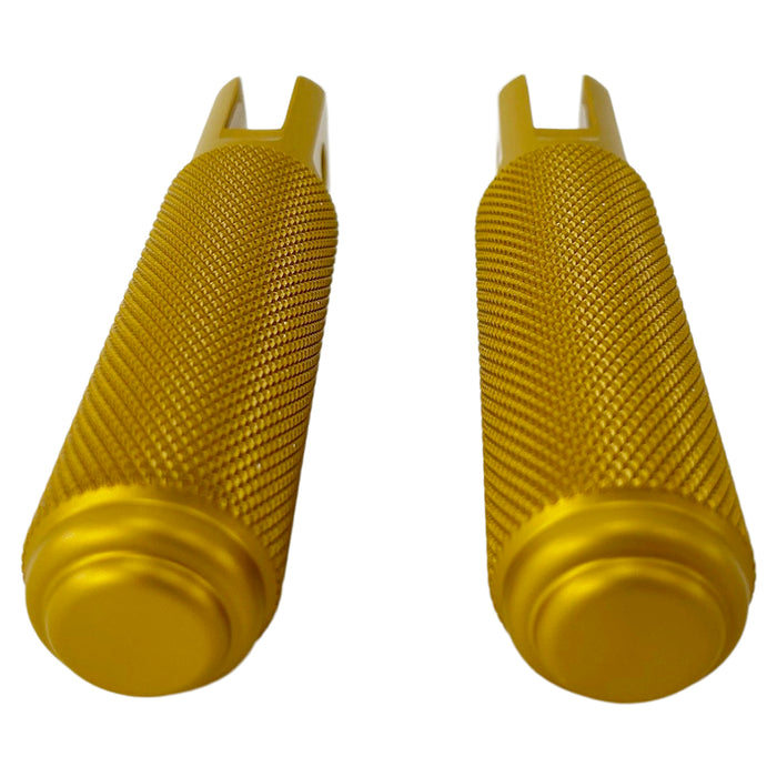 Two yellow metal TC Bros. Nomad Rider Foot Pegs fits 2018-up Harley Softail M8 & Pan America - Gold with textured grips, featuring attachment holes on one end of each peg.