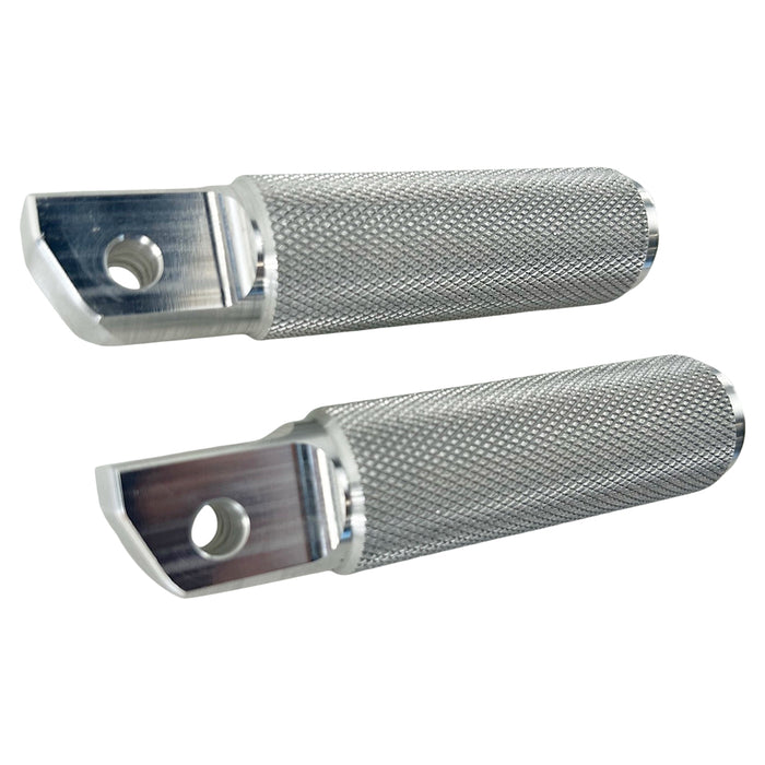 Two stainless steel TC Bros. Nomad Passenger Foot Pegs fits 2018-up Harley Softail M8 & Pan America, one upright and one lying on its side, showcasing their textured grip surfaces and mounting holes—perfect for adding a touch of rugged functionality.