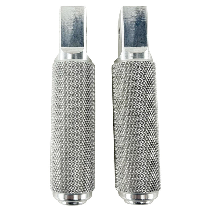 Two stainless steel TC Bros. Nomad Passenger Foot Pegs fits 2018-up Harley Softail M8 & Pan America, one upright and one lying on its side, showcasing their textured grip surfaces and mounting holes—perfect for adding a touch of rugged functionality.