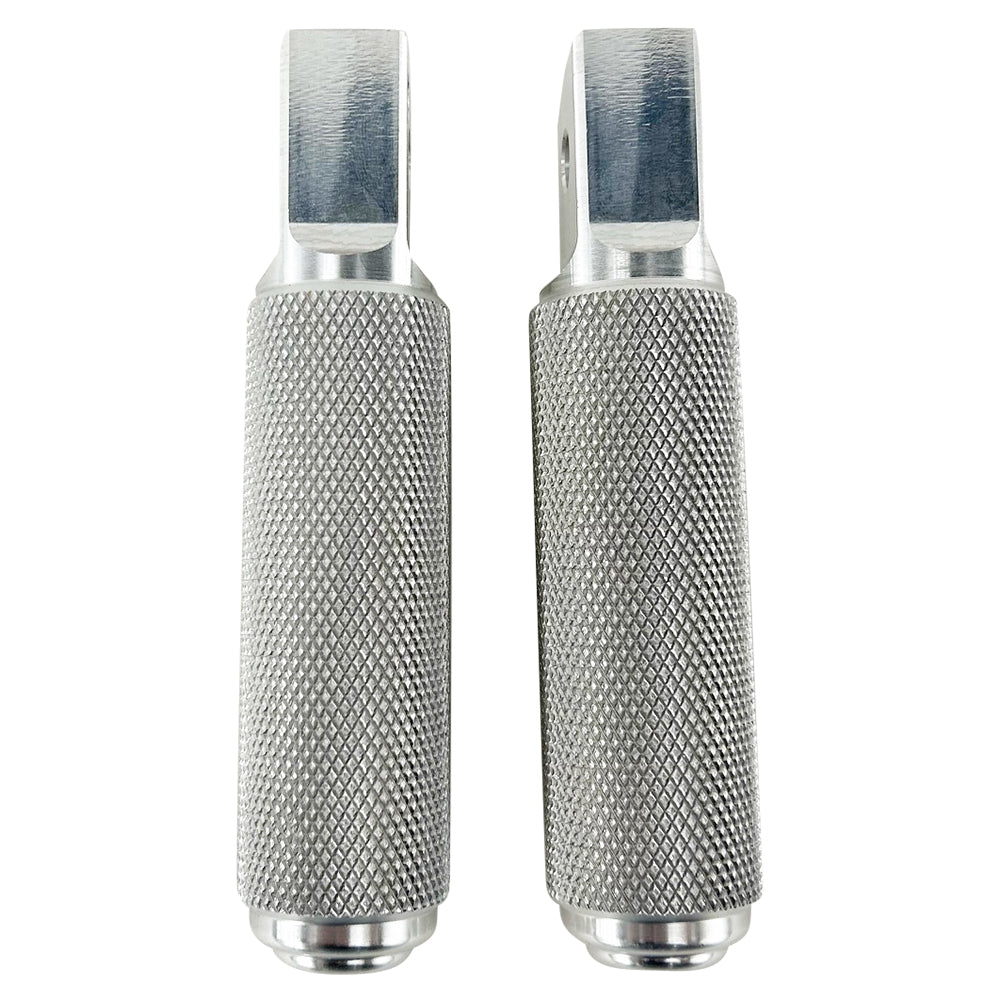 Two stainless steel TC Bros. Nomad Passenger Foot Pegs fits 2018-up Harley Softail M8 & Pan America, one upright and one lying on its side, showcasing their textured grip surfaces and mounting holes—perfect for adding a touch of rugged functionality.