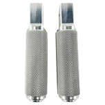 Two stainless steel TC Bros. Nomad Passenger Foot Pegs fits 2018-up Harley Softail M8 & Pan America, one upright and one lying on its side, showcasing their textured grip surfaces and mounting holes—perfect for adding a touch of rugged functionality.