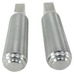 Two stainless steel TC Bros. Nomad Passenger Foot Pegs fits 2018-up Harley Softail M8 & Pan America, one upright and one lying on its side, showcasing their textured grip surfaces and mounting holes—perfect for adding a touch of rugged functionality.