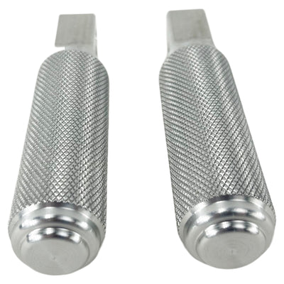 Two stainless steel TC Bros. Nomad Passenger Foot Pegs fits 2018-up Harley Softail M8 & Pan America, one upright and one lying on its side, showcasing their textured grip surfaces and mounting holes—perfect for adding a touch of rugged functionality.