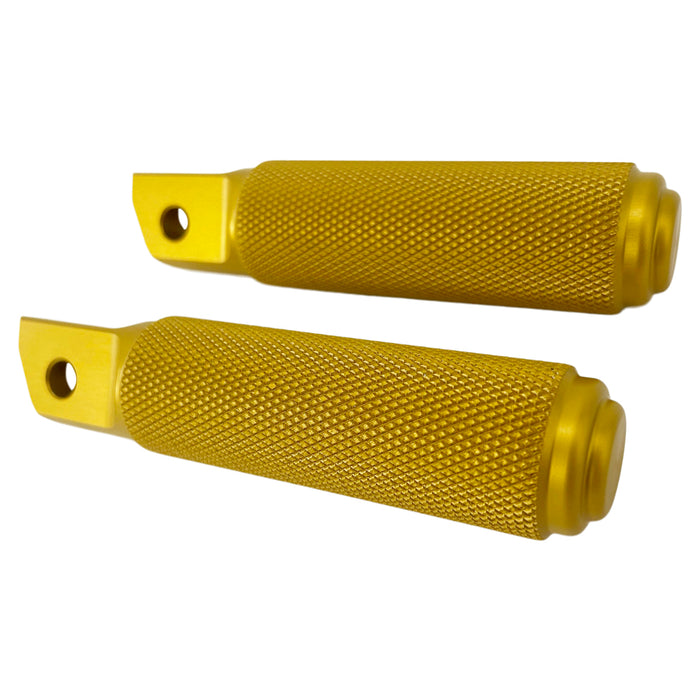 Two gold-tone metal cylindrical objects with textured grips, featuring a hole through their flat end pieces, arranged in a straight line. Crafted from CNC machined aluminum, these resemble TC Bros Nomad Passenger Foot Pegs fits 2018-up Harley Softail M8 & Pan America - Gold.