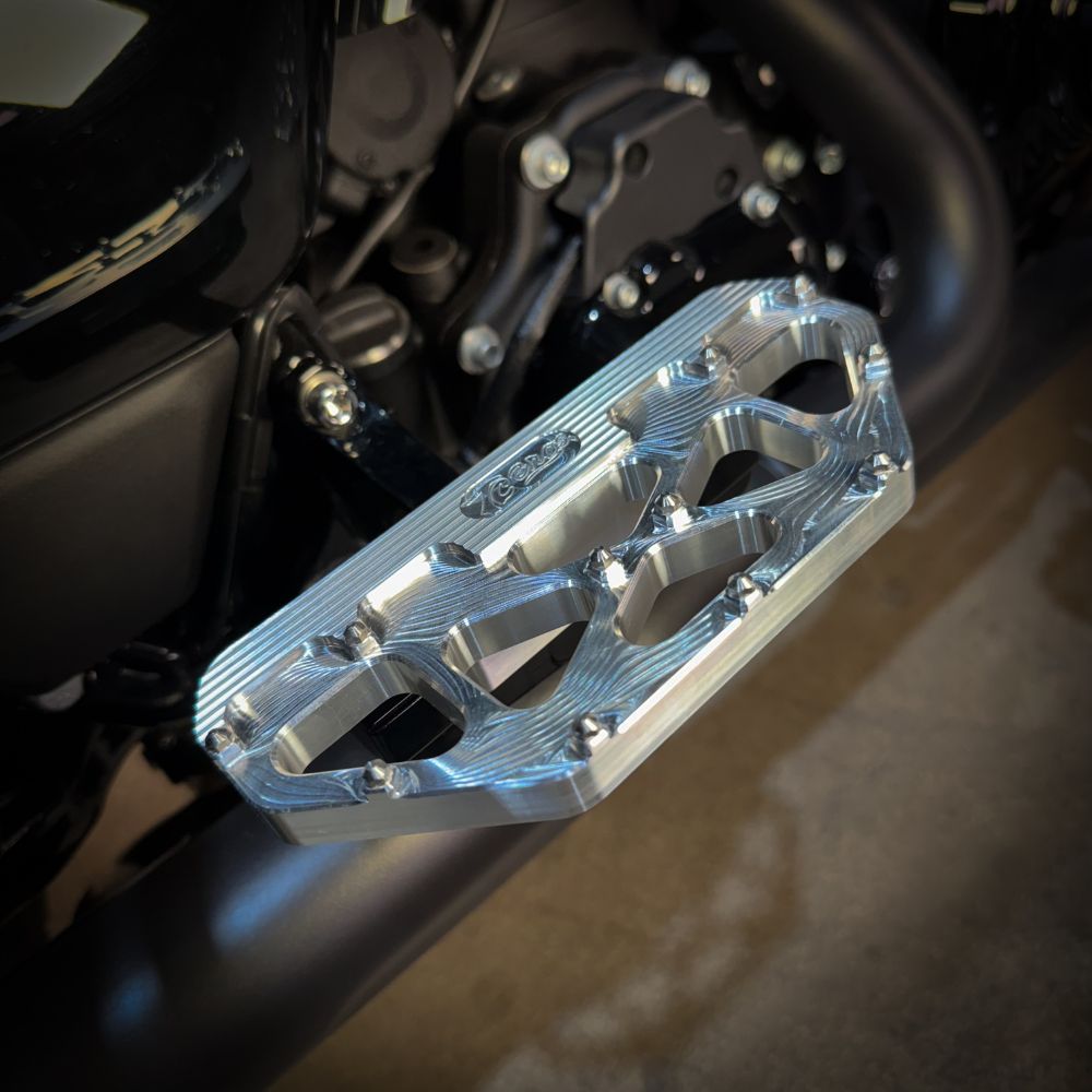 Three TC Bros. Pro Series MX Passenger Floorboards in black, silver, and gold are displayed on a white background, highlighting their design and color variations—perfect for Harley Davidson Bagger Touring enthusiasts seeking style and functionality.