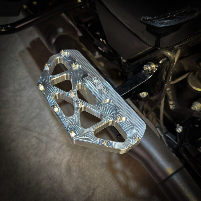 Three TC Bros. Pro Series MX Passenger Floorboards in black, silver, and gold are displayed on a white background, highlighting their design and color variations—perfect for Harley Davidson Bagger Touring enthusiasts seeking style and functionality.