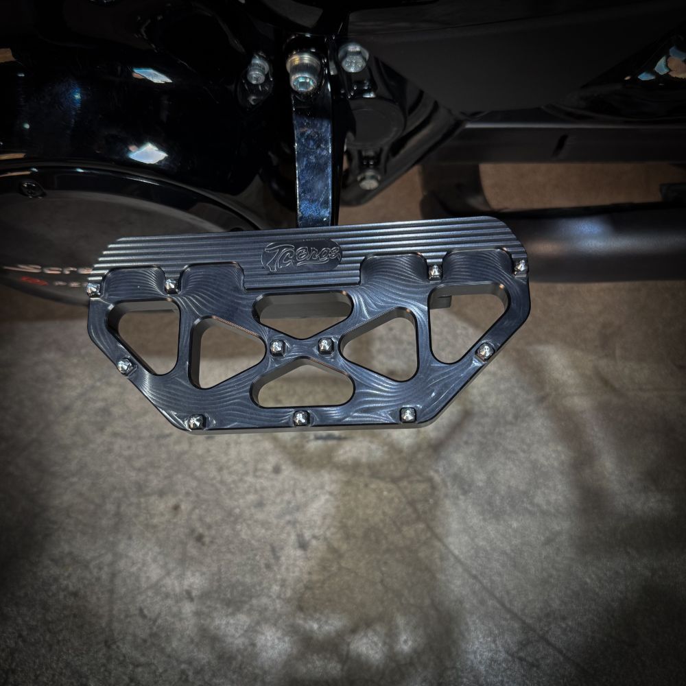 Three TC Bros. Pro Series MX Passenger Floorboards in black, silver, and gold are displayed on a white background, highlighting their design and color variations—perfect for Harley Davidson Bagger Touring enthusiasts seeking style and functionality.