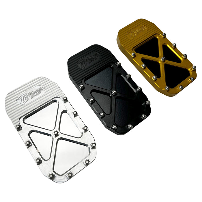 Three metallic foot pedals—silver, black, and gold—with textured grips and bolts are lined up side by side, capturing the sleek TC Bros. Pro Series MX Brake Pedal Pad design for Harley Davidson Bagger Touring Models.