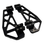 Close-up of TC Bros. Pro Series MX Slim Floorboards for 1984-Up Harley-Davidson Touring, featuring CNC-machined billet aluminum and visible bolts, mounted on a black Harley-Davidson motorcycle on a concrete floor.
