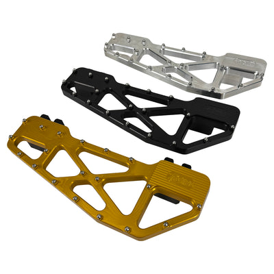 TC Bros. Pro Series MX Slim Floorboards for Harley Davidson Bagger Touring Models feature a skeletal design with metal pins, resembling high-performance pedals in silver, black, and gold. Arranged diagonally, they offer a striking visual appeal.