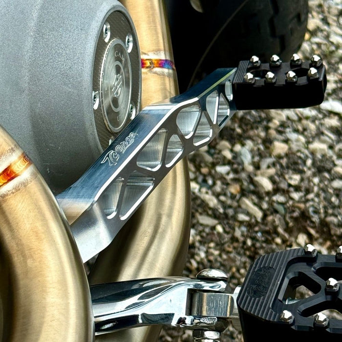 The TC Bros. Pro Series Truss Brake Pedal fits 1991-2017 Harley-Davidson Dyna models, featuring a billet aluminum construction with cut-out triangular patterns and mounting holes.