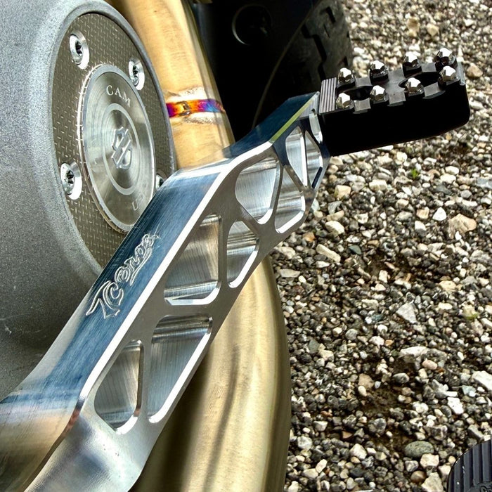 The TC Bros. Pro Series Truss Brake Pedal fits 1991-2017 Harley-Davidson Dyna models, featuring a billet aluminum construction with cut-out triangular patterns and mounting holes.