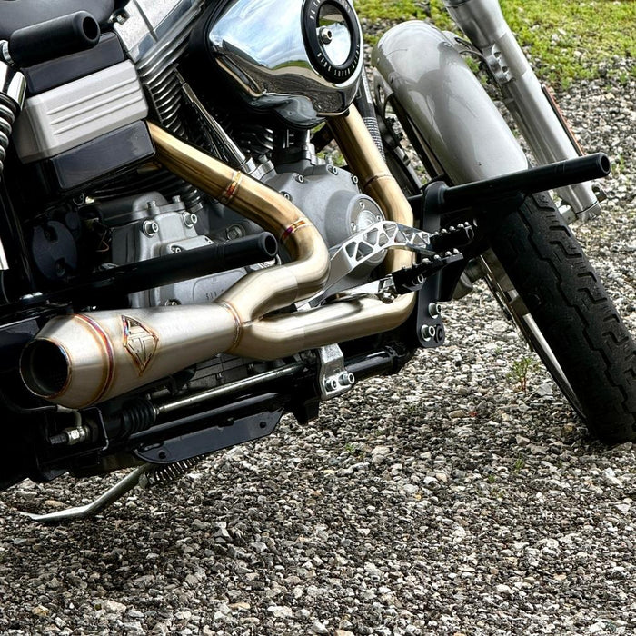 The TC Bros. Pro Series Truss Brake Pedal fits 1991-2017 Harley-Davidson Dyna models, featuring a billet aluminum construction with cut-out triangular patterns and mounting holes.