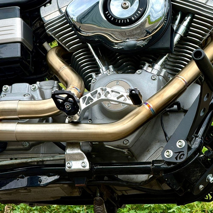 The TC Bros. Pro Series Truss Brake Pedal fits 1991-2017 Harley-Davidson Dyna models, featuring a billet aluminum construction with cut-out triangular patterns and mounting holes.