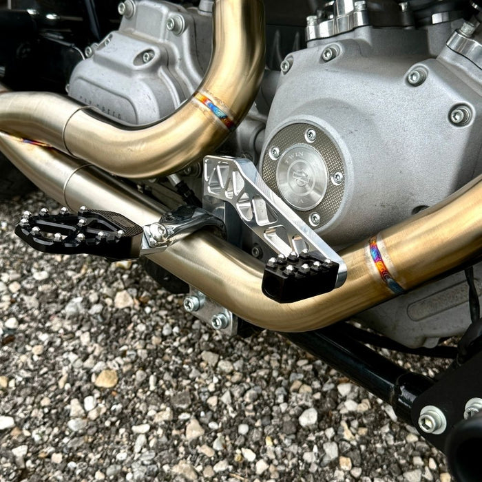 The TC Bros. Pro Series Truss Brake Pedal fits 1991-2017 Harley-Davidson Dyna models, featuring a billet aluminum construction with cut-out triangular patterns and mounting holes.