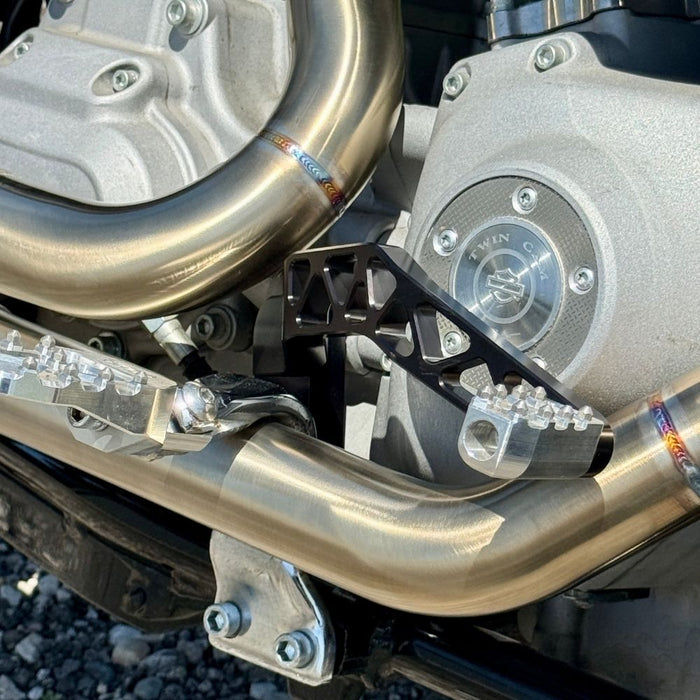 The TC Bros. Pro Series Truss Brake Pedal fits 1991-2017 Harley-Davidson Dyna models, featuring a billet aluminum construction with cut-out triangular patterns and mounting holes.