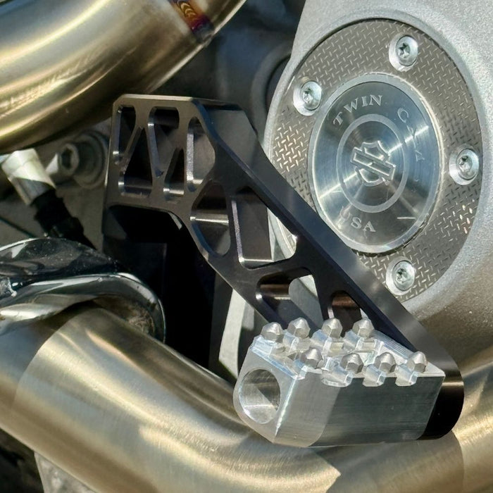 The TC Bros. Pro Series Truss Brake Pedal fits 1991-2017 Harley-Davidson Dyna models, featuring a billet aluminum construction with cut-out triangular patterns and mounting holes.